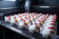 A full plate of multicolor Rapid Roost mini mascot chickens on the print bed